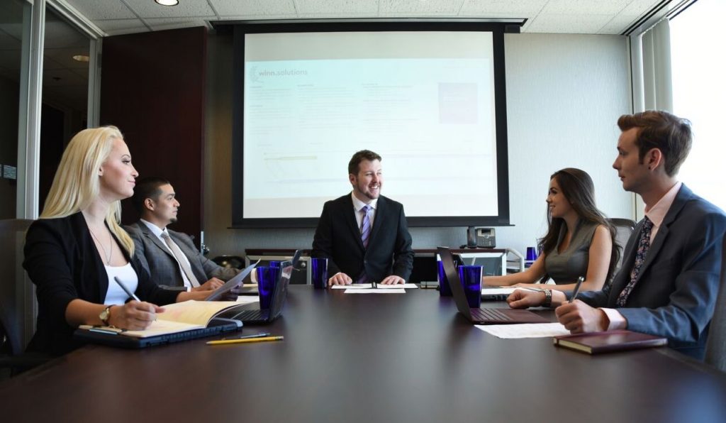 A group of people sitting at a desk